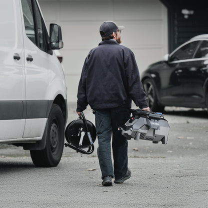 person taking portable jetter to do its job